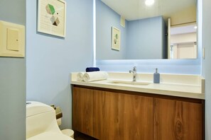 A bathroom with a wooden vanity, a sink, and a toilet. - Homey Atmosphere 3BR Flat steps from Provenza with A/C (Medellín)