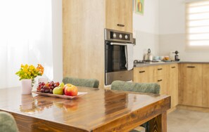 Enjoy cooking in this well-equipped kitchen with an oven and stove, perfect for preparing meals.