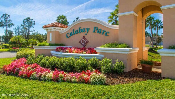 A sign for Calabay Parc with a landscaped garden in front.