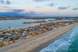 An aerial view of a coastal city with a long beachfront, dense residential area, and a marina. - Charming Beach Bungalow steps from the Ocean & Bay (San Diego)