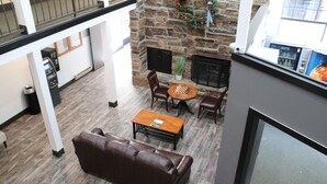 A spacious living area with a stone fireplace, leather sofa, and a coffee table. - Cozy and Clean Park City Studio (Park City)