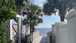 A wooden boardwalk leading to a private beach area with palm trees and a clear view of the ocean. - Classic Seagrove Cottage One Block from 30A Beach Access (Santa Rosa Beach)