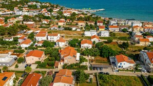 Un quartier résidentiel avec des maisons, une piscine et une vue sur la mer.