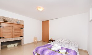 Relax in a serene bedroom with a comfortable bed, a stylish wardrobe, and a convenient bedside table.