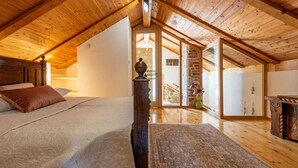 A bedroom with a wooden ceiling, a bed with a headboard, a nightstand, and a dresser. - Villa Rosemary Zadarvillas (Policnik)