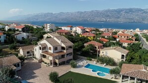 A residential area with a large house featuring a swimming pool and multiple balconies. - Villa Zlatni Dvori Zadarvillas (Razanac)