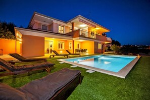 A two-story house with a swimming pool, outdoor seating, and a well-lit balcony. - Villa Sky Zadarvillas (Rovinj)