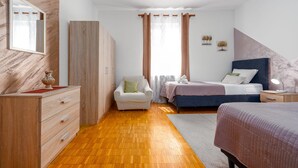 A bedroom with a wooden wardrobe, a bedside table with a lamp, a bed with a headboard, and a window with curtains. - Villa Me Trovi Zadarvillas (Zadar)