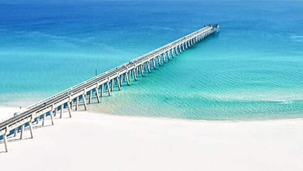 A long pier extending into a clear blue sea with a sandy beach at the end. - Beach house 3BR/3.5BA 5 minute walk to bay with extra parking for a boat/RV (Navarre)