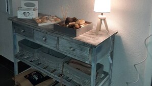 A room with a wooden dresser, a mirror, and a lamp. - Twin house T4 for 6 persons (MESSANGES)