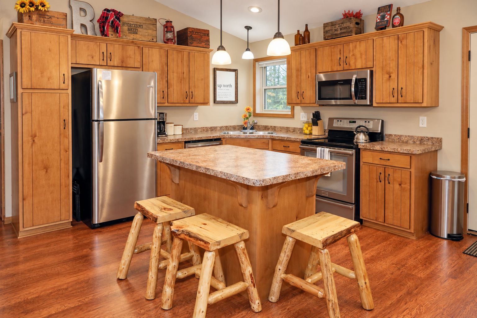 Rustic kitchen with island seating and stainless steel appliances
