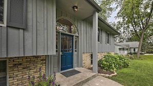 A house with a blue front door, a brick lower section, and a small front porch. - Lake Nagawicka Home - 2 Blocks to Boat Launch (Delafield)
