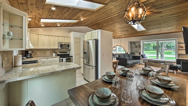 A spacious kitchen with wooden ceiling, a large island, and modern appliances. - Lake Nagawicka Home - 2 Blocks to Boat Launch (Delafield)
