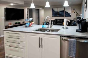 A modern kitchen with a central island, a built-in dishwasher, and pendant lighting. - Highland/Lehi Tech hub (Lehi)
