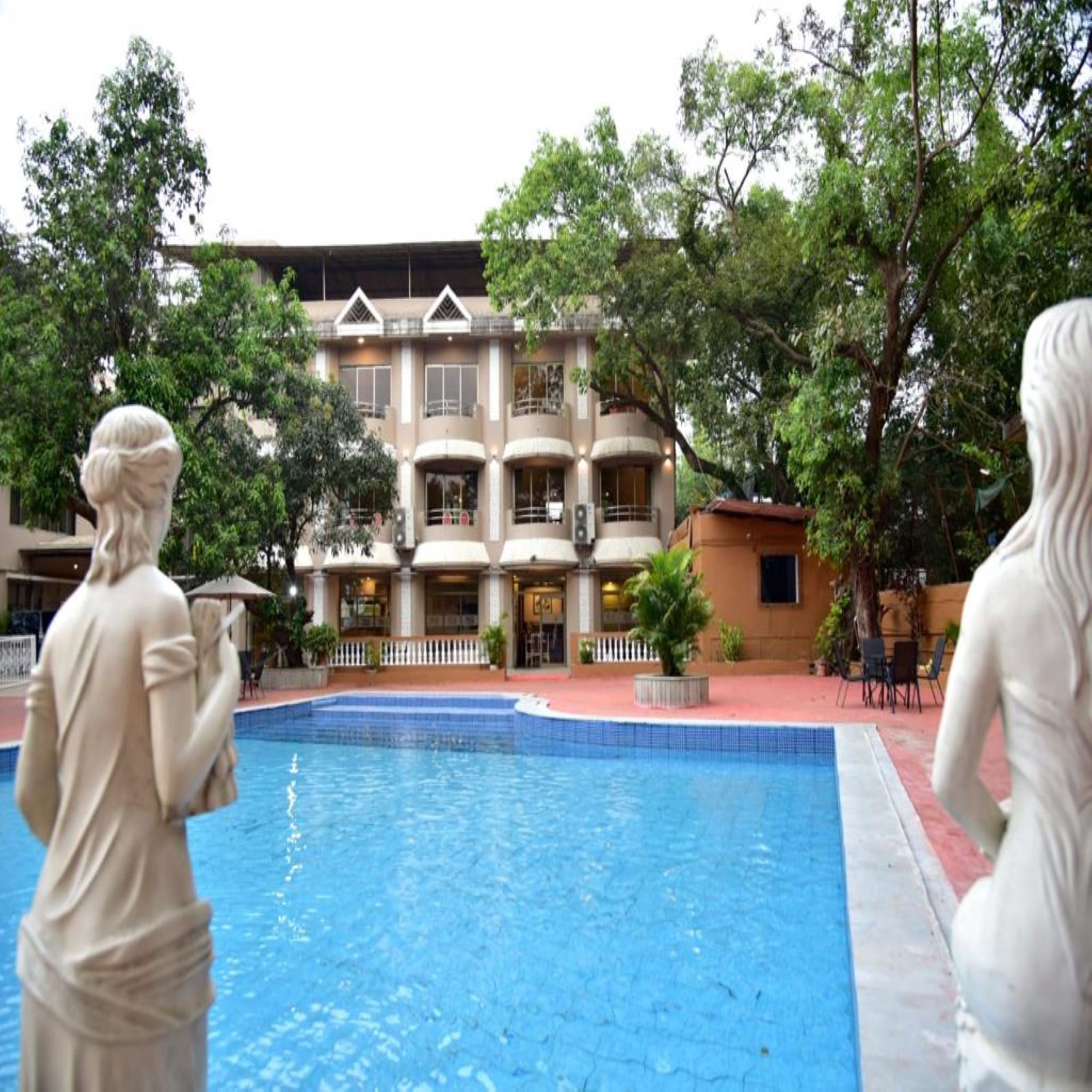 A pool area with a building in the background.