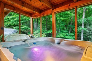 A hot tub with a view of a forest. - Beautiful cabin! Book now! 2 master suites - Sleeps 6 - Hot Tub  (Sevierville)