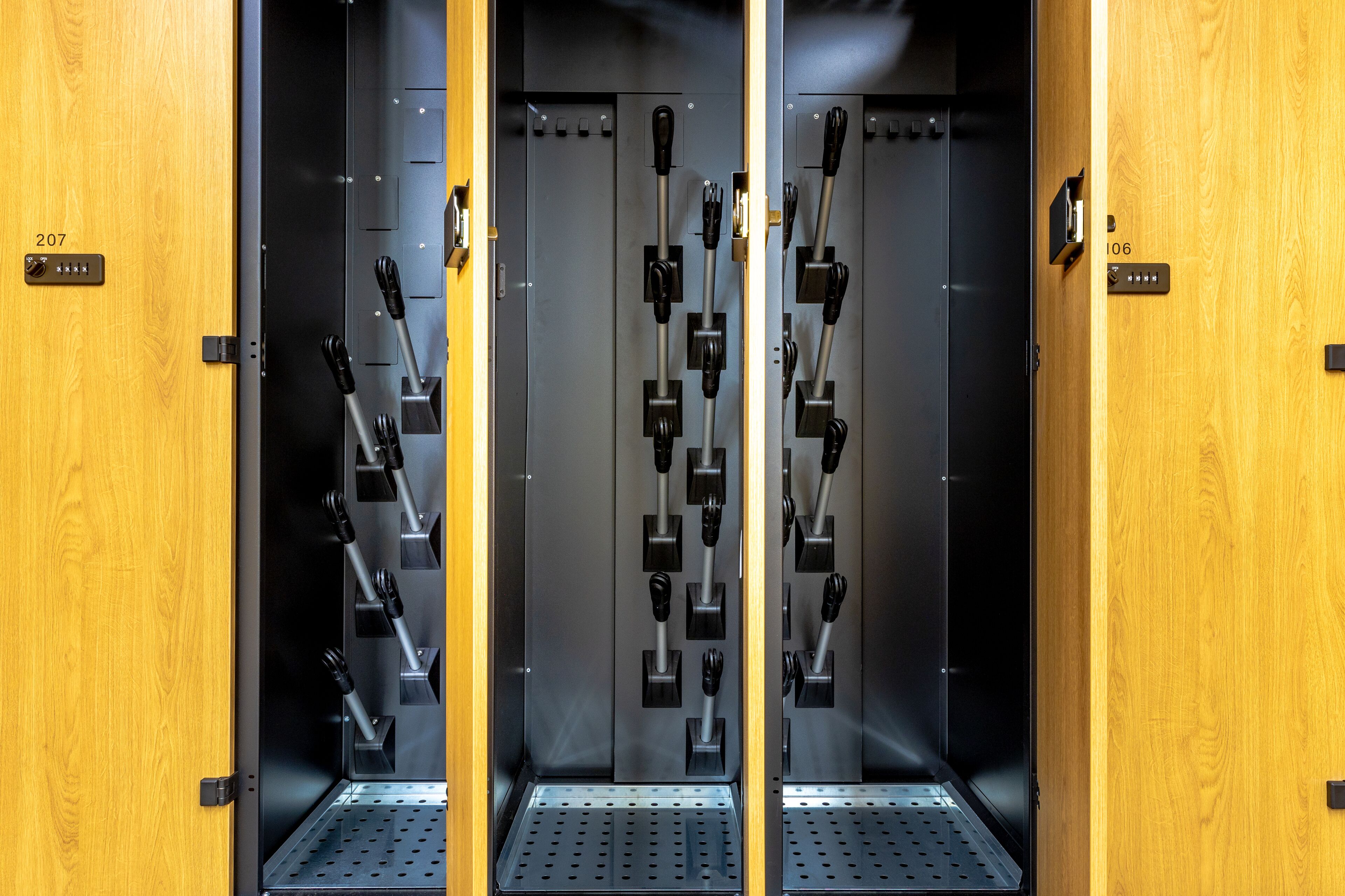 Three metal safes with black handles, each marked with a number (207, 106).