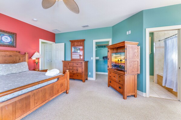 Une chambre à coucher avec un lit, une commode en bois et un placard.