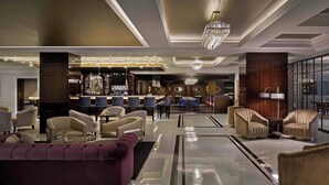 A modern lobby with a bar area, plush seating, and a chandelier. - The LaSalle Chicago, Autograph Collection by Marriott (Chicago)