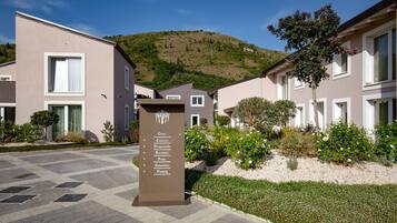 A signpost with directions to various amenities including a gym, restaurant, and parking.
