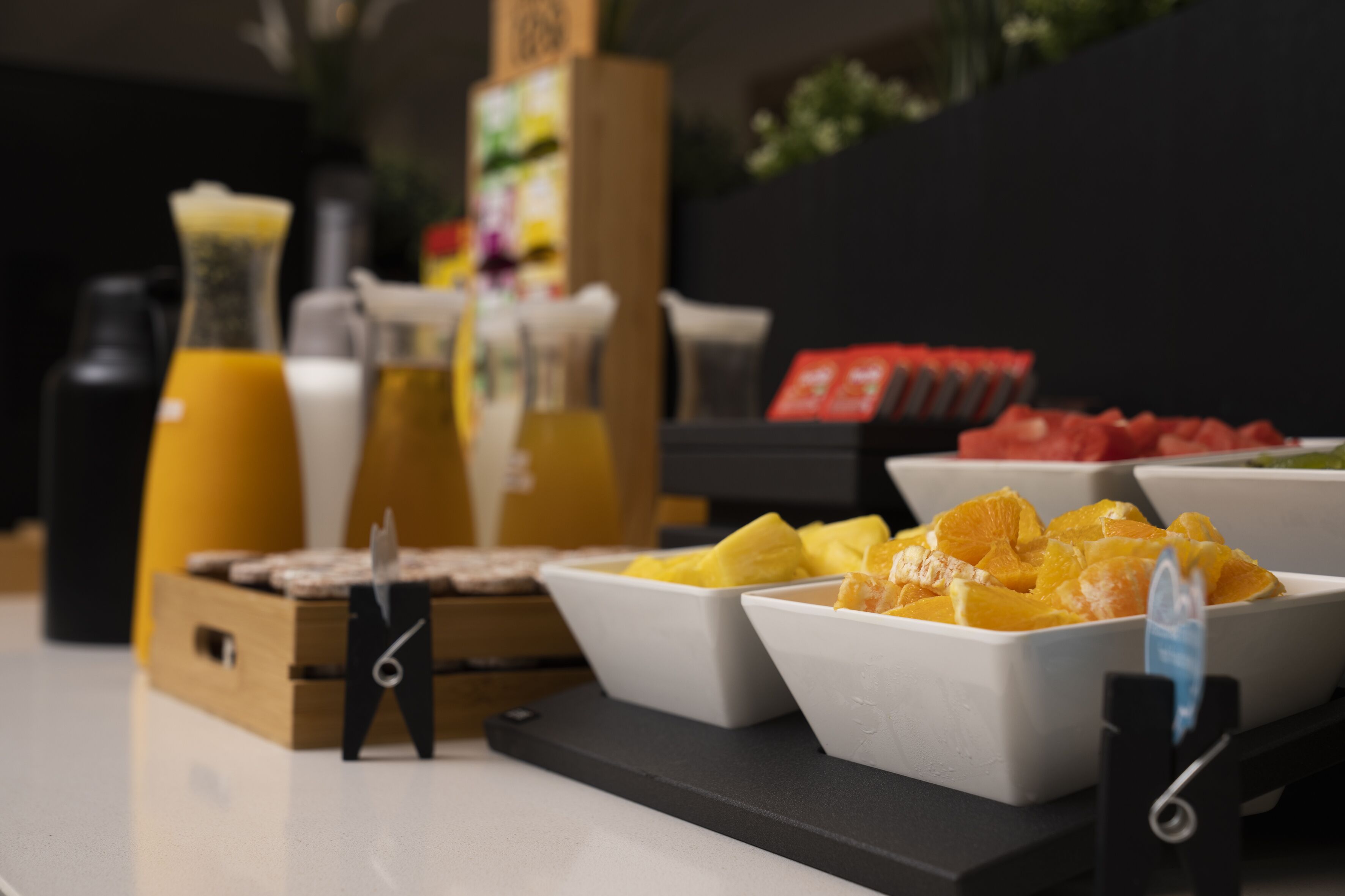 A breakfast buffet with various fruits and beverages.