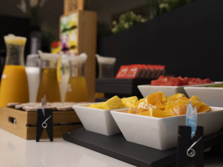 A breakfast buffet with various fruits and beverages.