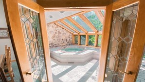 A spa area with a hot tub, stone walls, and wooden beams. - Chateaux Dumont 2725 (Keystone)