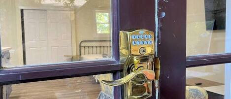 A door with a brass keyhole and a numeric keypad lock.