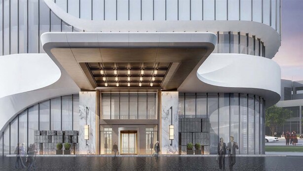 A modern building with a curved facade, large glass windows, and a prominent entrance with a light fixture above. - HUALUXE Qingdao Licang by IHG (Qingdao)