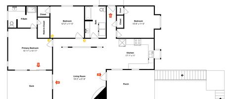 A floor plan of a hotel with a primary bedroom, secondary bedroom, living room, kitchen, and a deck.