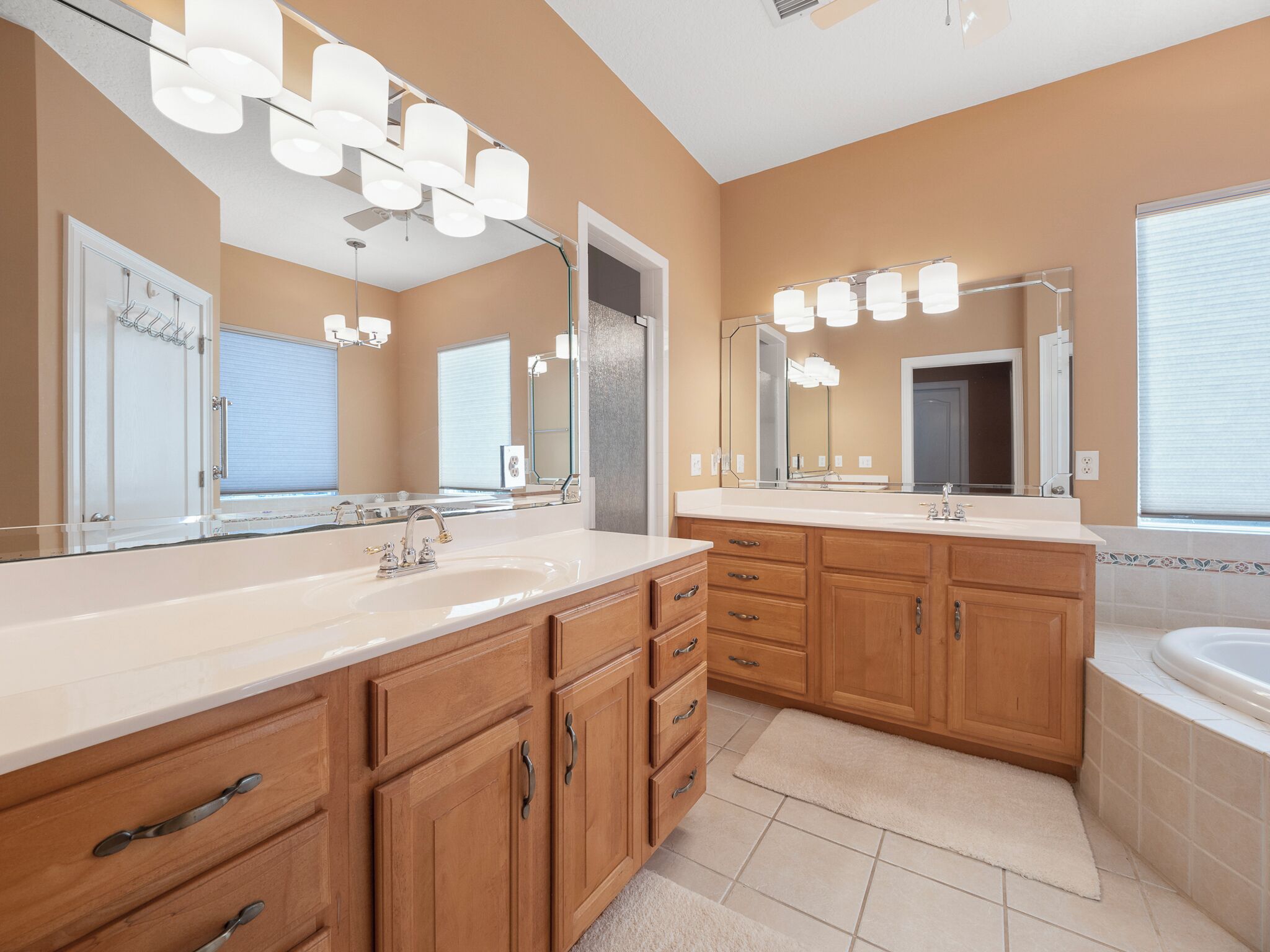 A modern bathroom with a large vanity, double sinks, and a walk-in shower.
