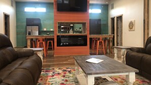 A living room with two brown leather sofas, a wooden coffee table, and a colorful rug. - Time For Livin…just a few steps from the Caddo River (Glenwood)
