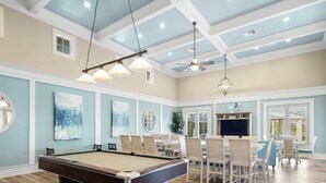 A pool table in a room with a high ceiling, recessed lighting, and a ceiling fan. - Three Palms by Distinctive Beach Rentals (Palm Coast)