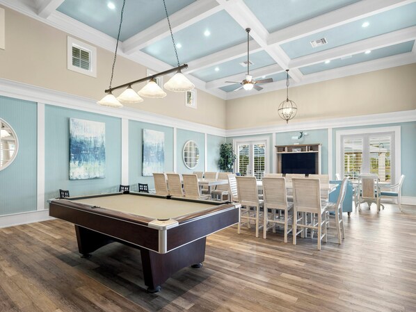 A pool table in a room with a high ceiling, recessed lighting, and a ceiling fan. - Three Palms by Distinctive Beach Rentals (Palm Coast)