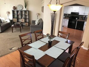 Cozy living and dining space with comfortable seating and a dining table for four.