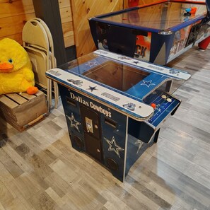 A foosball table with Dallas Cowboys branding, a plush toy duck, and a wooden chest. - Chickahominy Riverside Guest Home 30 Minutes to Williamsburg! (Charles City)