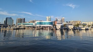 A marina with yachts docked, a modern building with blue accents, and a clear sky. - Arlington Park Area! 3BR/2BA Sarasota Home – Heated Large Pool (Sarasota)