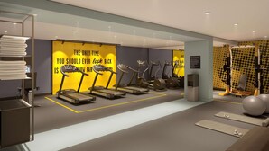 Een moderne fitnessruimte met loopbanden, elliptische trainers en een gewichthefzone.
