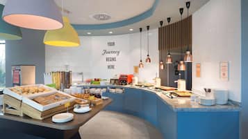 A breakfast buffet area with various food items and a sign that reads "YOUR JOURNEY BEGINS HERE".