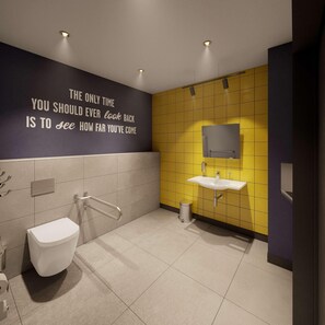 Ein modernes Badezimmer mit einem motivierenden Zitat an der Wand, einem weißen Waschbecken und einer Toilette.