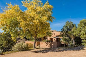 A modern building with a flat roof, surrounded by a variety of trees including a large yellow-leaved tree. - Acoma - Majestic Views, Near the Santa Fe Opera and Four Seasons in Tesuque (Santa Fe)