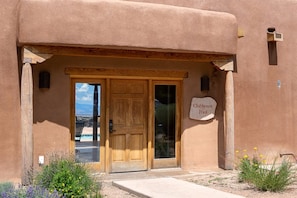 A building with a wooden door and a sign reading "Clubhouse Pool".