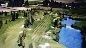 A golf course with a pond, sand bunkers, and trees. - Discover the diverse province of North Holland (Nieuwe Niedorp)