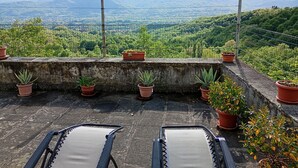 A rooftop terrace with potted plants and two sun loungers. - Cozy mini apartment on large terrace with unique view, pets allowed (Orturano)