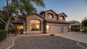 A modern two-story house with a garage, a driveway, and a landscaped front yard. - Sunshine and Good Times! Massive 5/bdrm with Pool, Hot Tub, and Game Room!  (Gilbert)