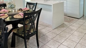 A modern kitchen with white cabinets, a central island, and a ceiling fan. - Live Tropical like a local , El Yunque Rainforest View, Mountain View  (Río Grande)