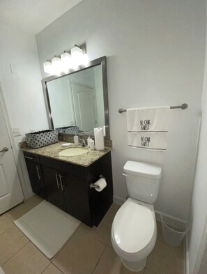 Combined shower/bathtub, towels, toilet paper