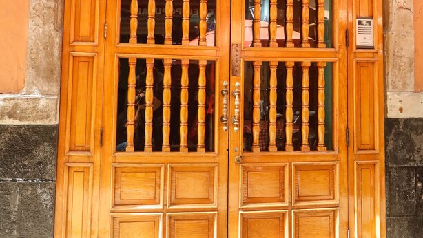 A wooden double door with a sign reading "HOTEL HUAREZ" above it. - Hotel Juarez (Mexico City)
