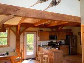 Enjoy cooking in this well-equipped kitchen with a central island, refrigerator, microwave, and stove.