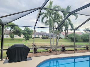 Enjoy al fresco dining and poolside relaxation under a transparent roof, surrounded by lush greenery and scenic views.